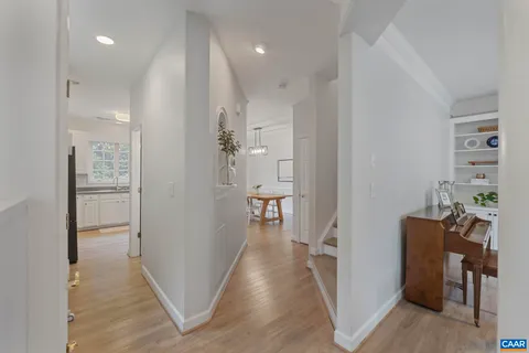a view of a hallway with wooden floor windows and livingroom