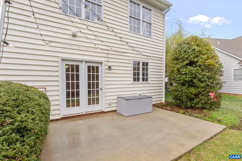 a kitchen with stainless steel appliances granite countertop a refrigerator a sink dishwasher a stove and white countertops with wooden floor