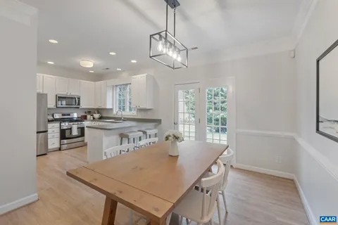 a kitchen with stainless steel appliances white cabinets and a potted plant