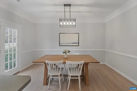 a view of a dining room with furniture wooden floor and chandelier