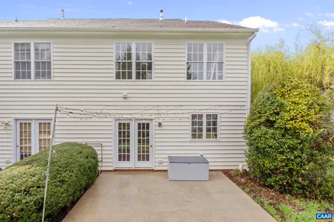 an entryway with wooden floor and windows