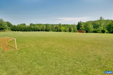 a view of a chairs and table in patio with wooden floor