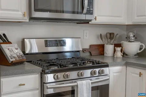 a white stove top oven sitting inside of a kitchen