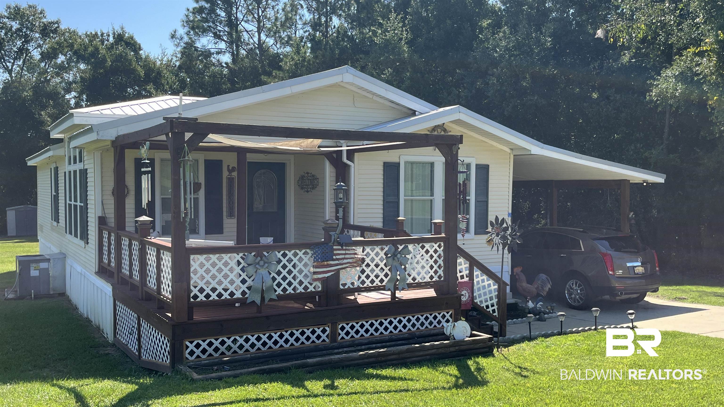 12932 Santa Piedro Street Lillian, AL 36549 - Photo 2 of 20 View of front facade with a front yard, a carport, driveway, and covered porch