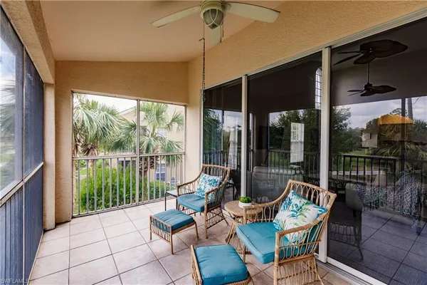 a building outdoor space with patio furniture and glass door