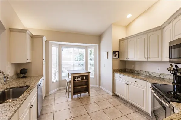 a kitchen with a stove a sink and a refrigerator