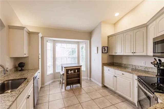 a kitchen with a stove a sink and a refrigerator