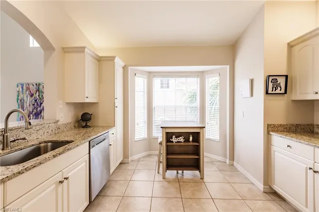 a kitchen with a stove sink and cabinets