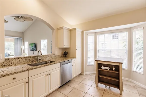 a spacious bathroom with a sink a mirror and a bathtub