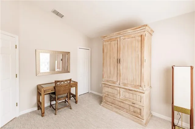 a view of a bedroom with workspace and a window