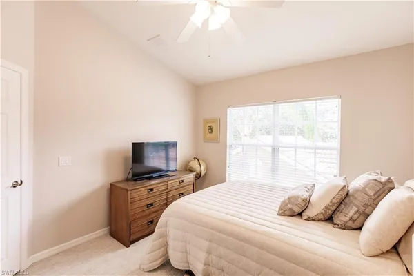 a bedroom with a bed and a tv