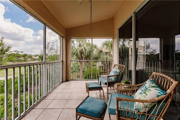 a balcony with chairs and city view