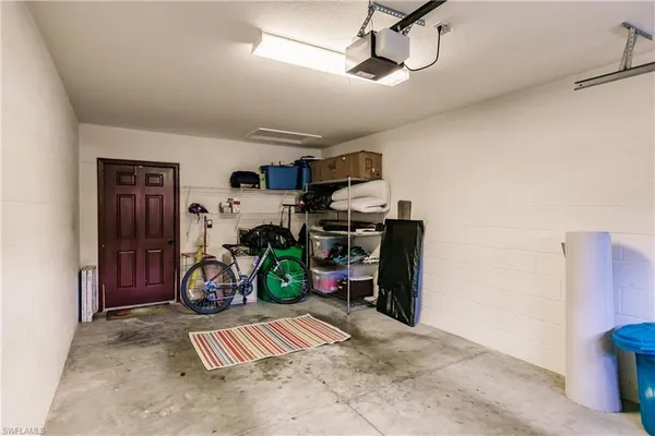 a view of a garage with a bike and car