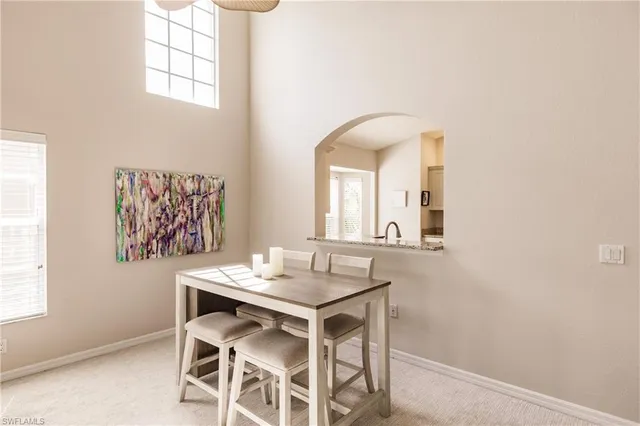 a view of a dining room that has a table and chairs in it
