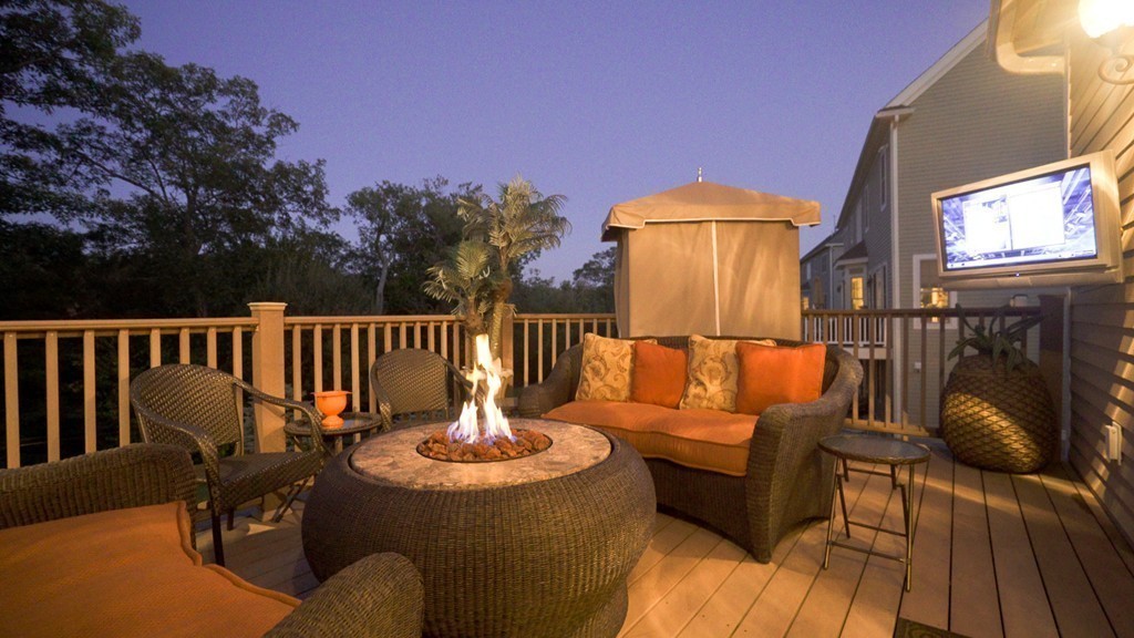 29 Hilltop Avenue Saugus, MA 01906 - Photo 14 of 30 a view of a deck with couches table and chairs and wooden floor