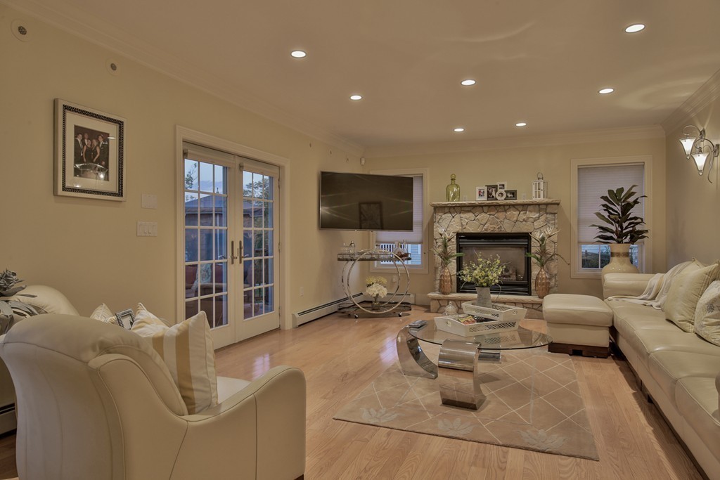 29 Hilltop Avenue Saugus, MA 01906 - Photo 21 of 30 a living room with furniture a fireplace and a flat screen tv