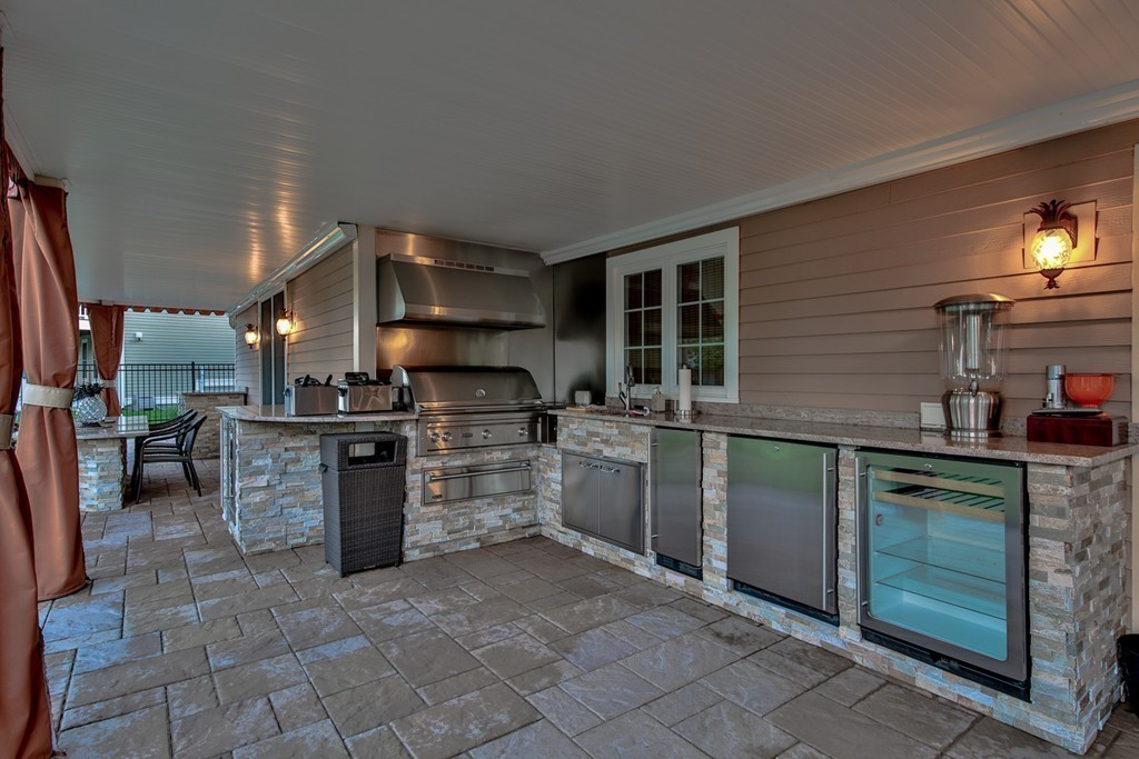 29 Hilltop Avenue Saugus, MA 01906 - Photo 7 of 30 a kitchen with stainless steel appliances granite countertop a stove a sink and a refrigerator