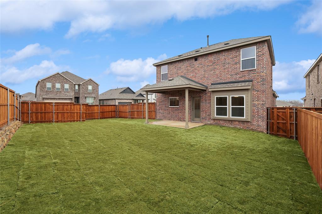 3900 Coco Lane Sherman, TX 75090 - Photo 26 of 40 Back of house with a yard and a patio