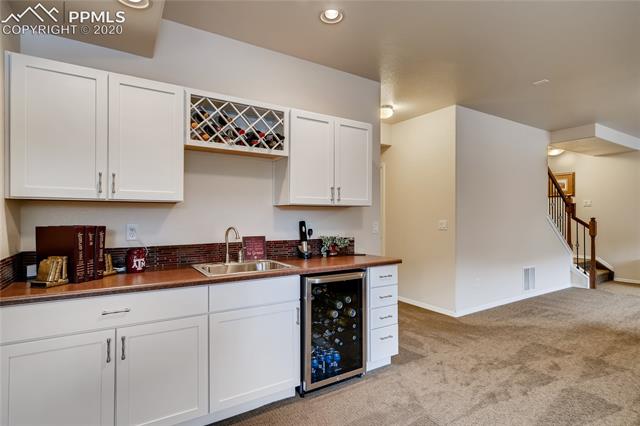 7676 Wichita Ridge Point Colorado Springs, CO 80923 - Photo 19 of 34 Basement has large rec room with wet bar