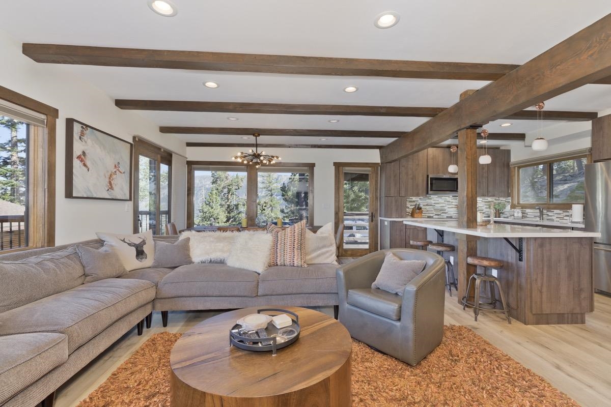 670 John Muir Road, Unit 1 Mammoth Lakes, CA 93546 - Photo 1 of 50 Living area featuring recessed lighting, a chandelier, light wood-style flooring, and beam ceiling