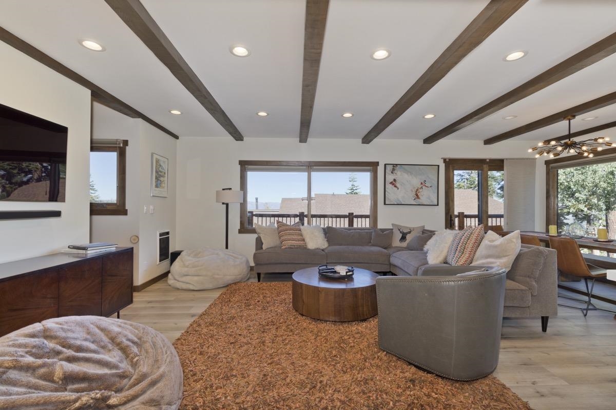 670 John Muir Road, Unit 1 Mammoth Lakes, CA 93546 - Photo 4 of 50 Living area featuring light wood-type flooring, a chandelier, recessed lighting, and beam ceiling