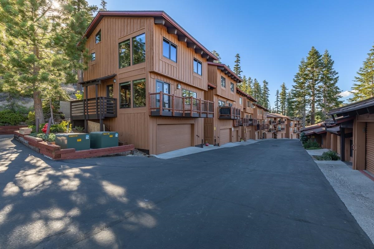 670 John Muir Road, Unit 1 Mammoth Lakes, CA 93546 - Photo 42 of 50 View of building exterior featuring an attached garage and asphalt driveway