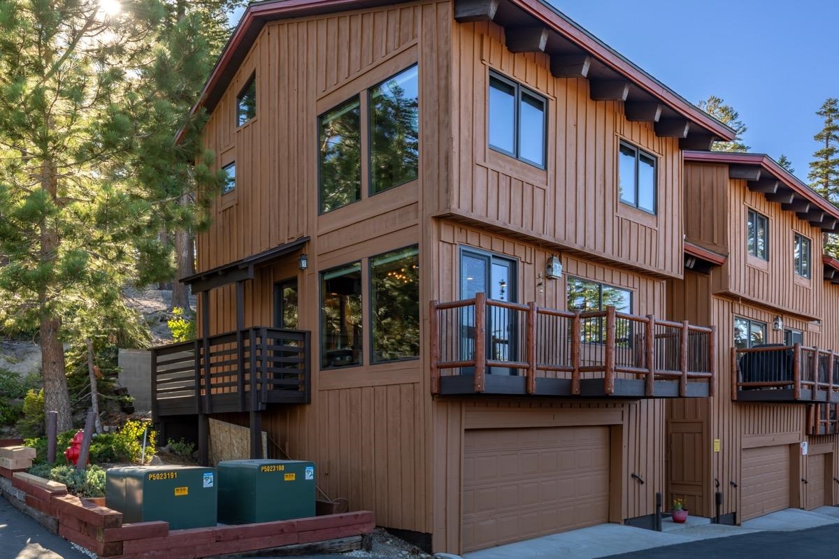 670 John Muir Road, Unit 1 Mammoth Lakes, CA 93546 - Photo 43 of 50 View of front of property featuring a garage, board and batten siding, and a balcony