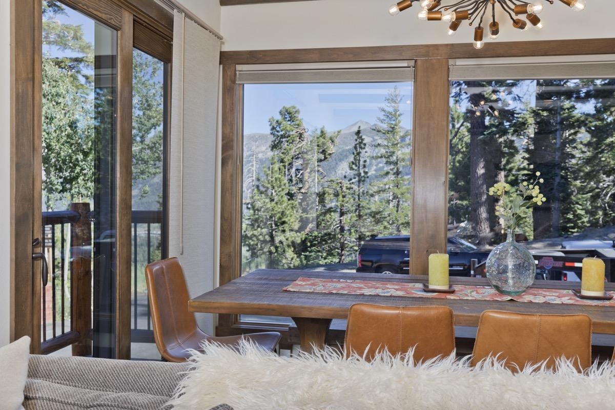 670 John Muir Road, Unit 1 Mammoth Lakes, CA 93546 - Photo 8 of 50 Dining area featuring a chandelier, a mountain view, and healthy amount of natural light