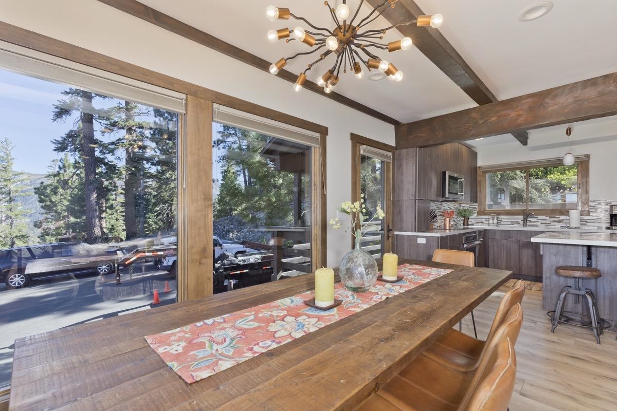 670 John Muir Road, Unit 1 Mammoth Lakes, CA 93546 - Photo 10 of 50 Dining area with light wood-style floors, beamed ceiling, and a chandelier