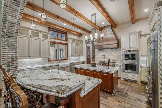 a kitchen with stainless steel appliances granite countertop a stove and a refrigerator