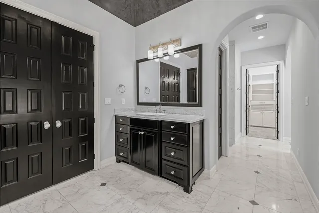 a bathroom with a sink vanity and a mirror
