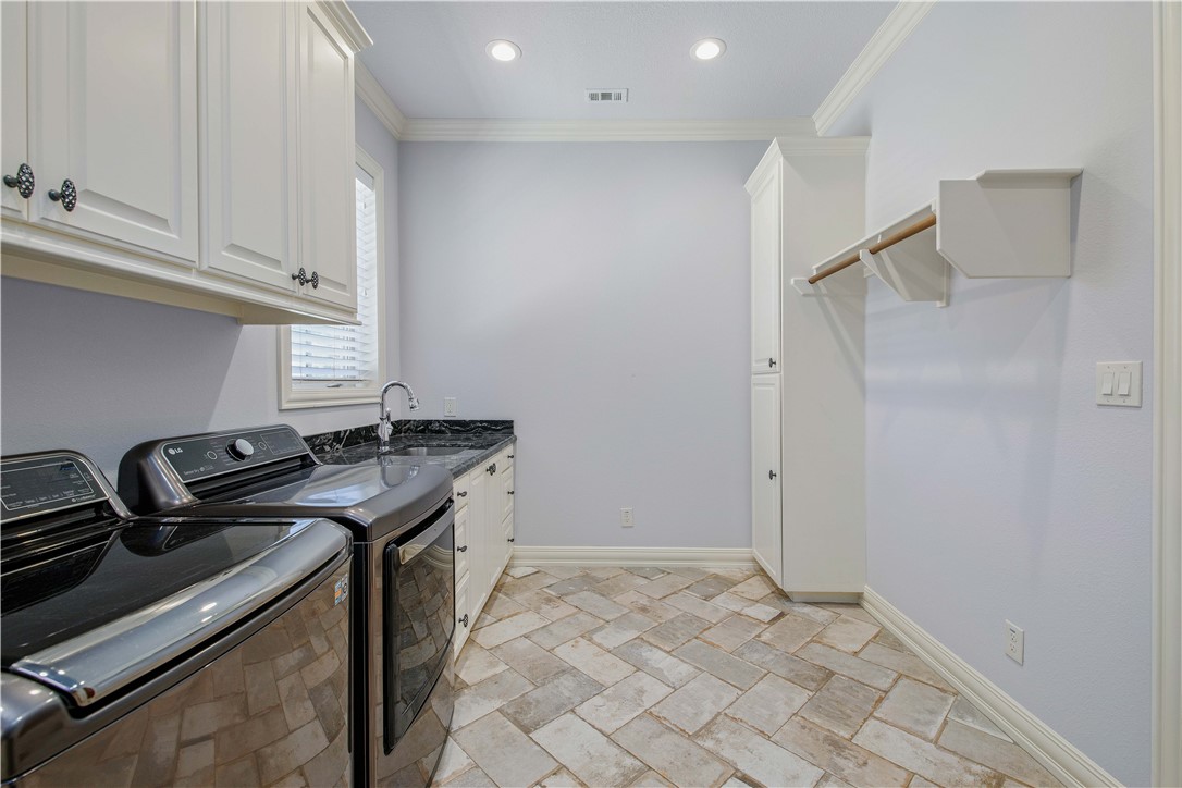 4207 Tuscany Court Bryan, TX 77802 - Photo 26 of 50 Laundry area featuring ornamental molding, washer and dryer, cabinet space, and recessed lighting