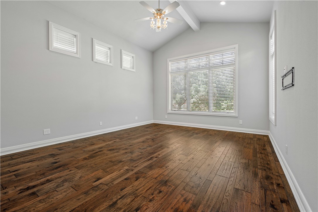 4207 Tuscany Court Bryan, TX 77802 - Photo 29 of 50 Empty room featuring plenty of natural light, dark wood-style floors, and a ceiling fan