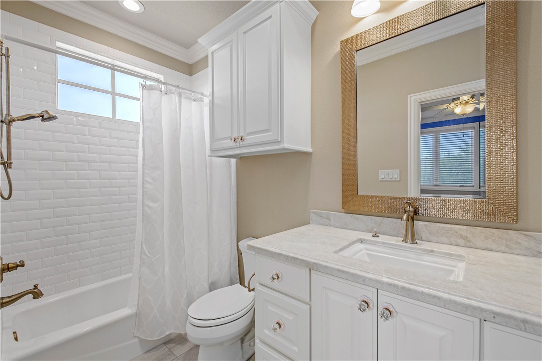 4207 Tuscany Court Bryan, TX 77802 - Photo 37 of 50 Bathroom with crown molding, shower / bath combo, and vanity