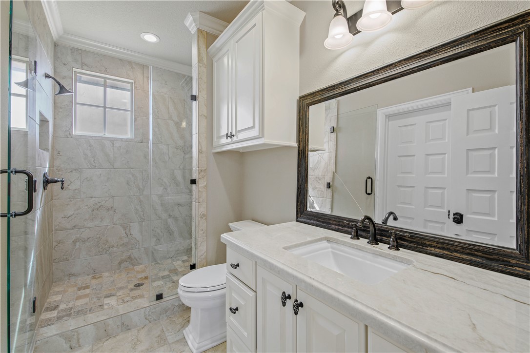 4207 Tuscany Court Bryan, TX 77802 - Photo 39 of 50 Full bath with vanity, a shower stall, crown molding, and recessed lighting