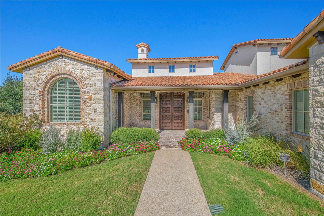 4207 Tuscany Court Bryan, TX 77802 - Photo 4 of 50 View of front of home with a chimney, a front yard, a porch, and stone siding