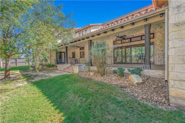 a porch with a table and chairs