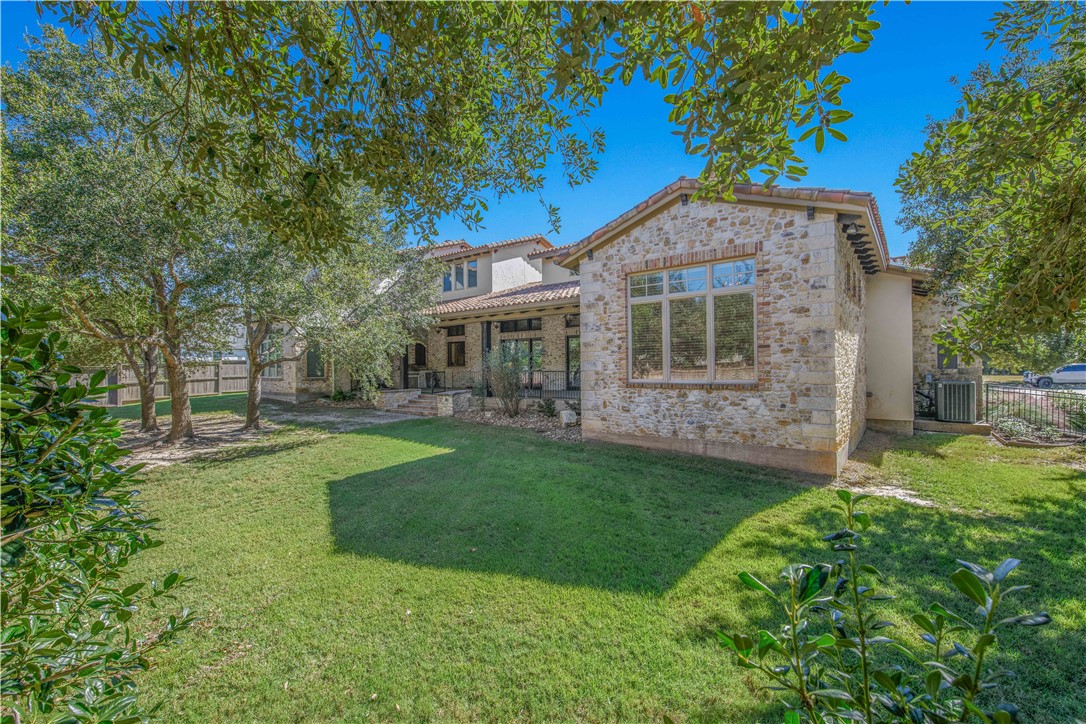 4207 Tuscany Court Bryan, TX 77802 - Photo 44 of 50 Rear view of property with a patio area, a tiled roof, stucco siding, and stone siding