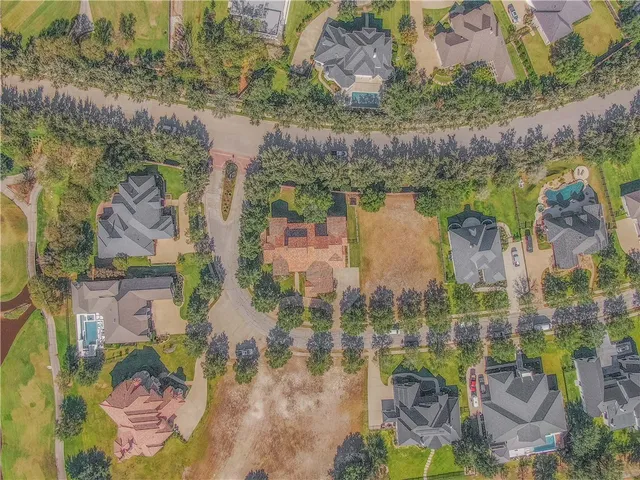 an aerial view of residential houses with outdoor space and river