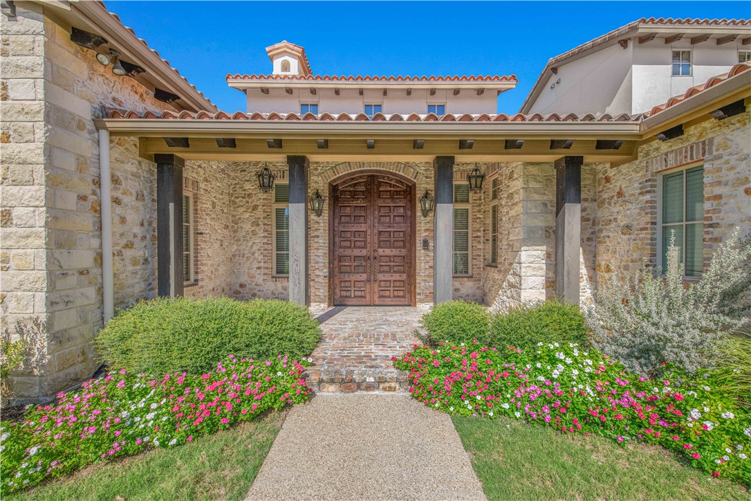 4207 Tuscany Court Bryan, TX 77802 - Photo 5 of 50 Property entrance featuring a porch, a chimney, and a tile roof