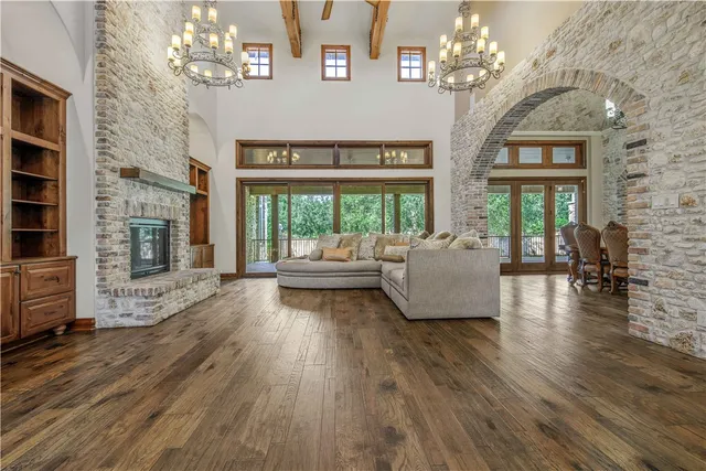 a living room with fireplace furniture and a chandelier
