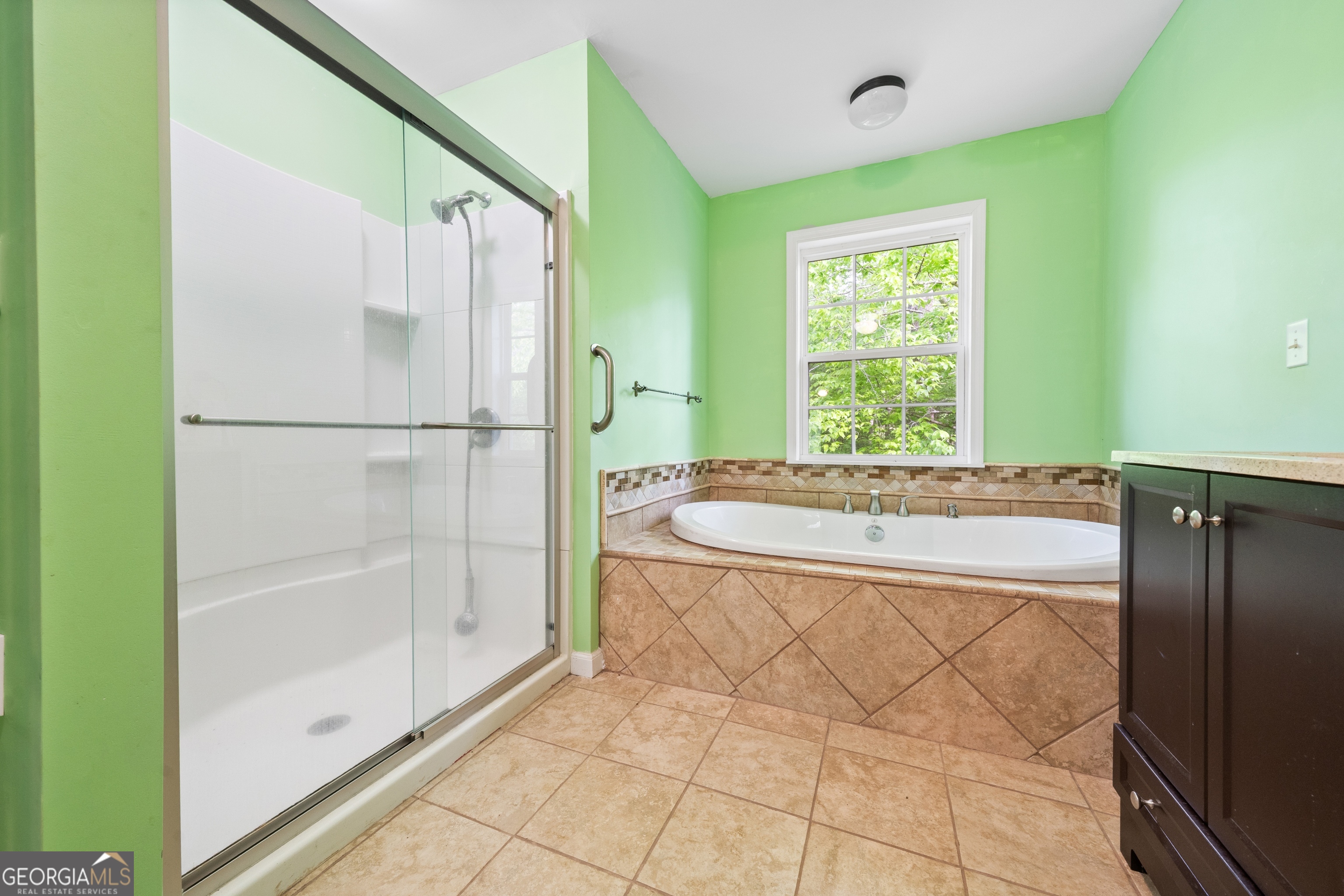 3719 County Road 88 Delta, AL 36258 - Photo 21 of 36 a bathroom with a granite countertop bathtub and a shower
