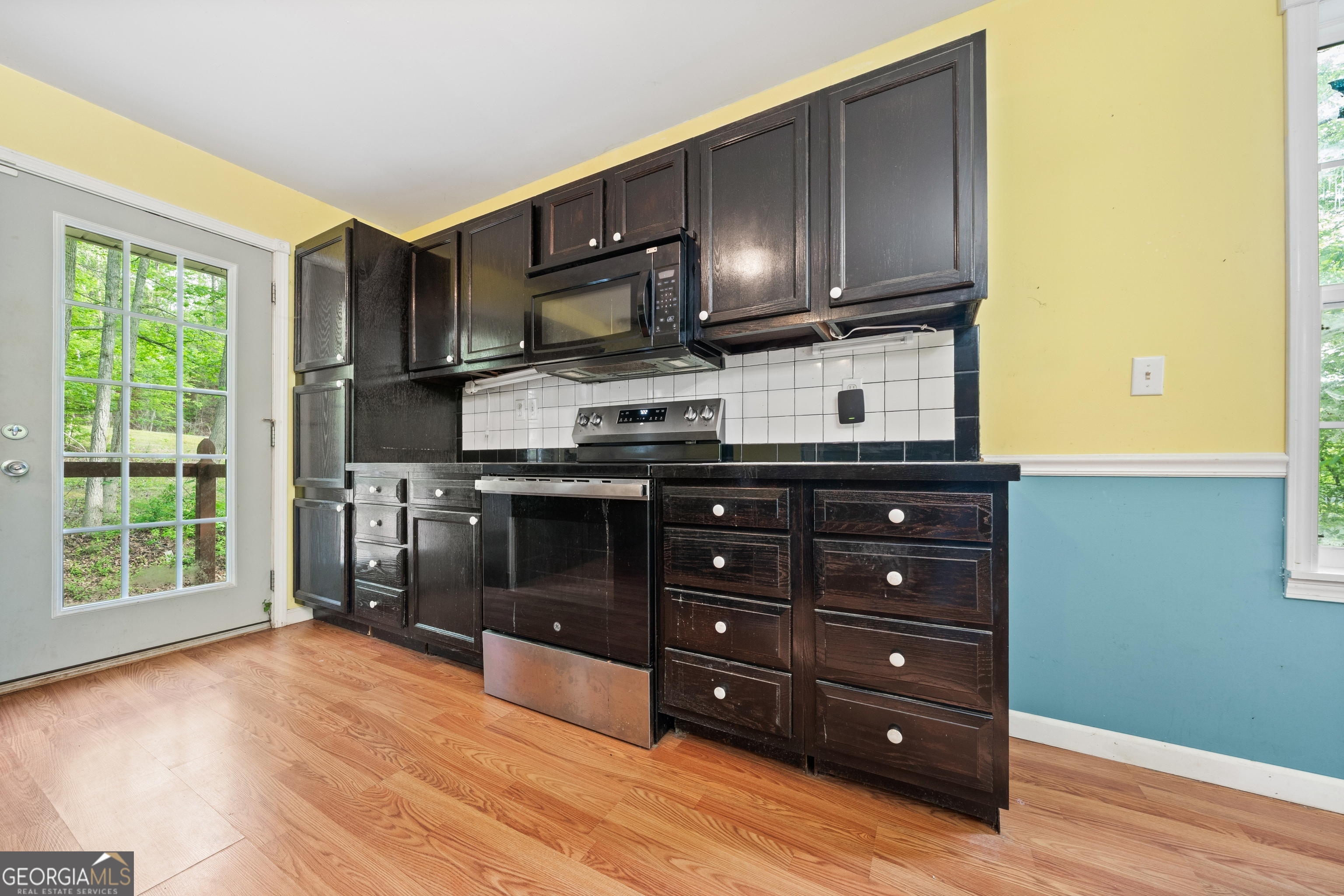 3719 County Road 88 Delta, AL 36258 - Photo 10 of 36 a kitchen with stainless steel appliances granite countertop a stove a microwave and a refrigerator