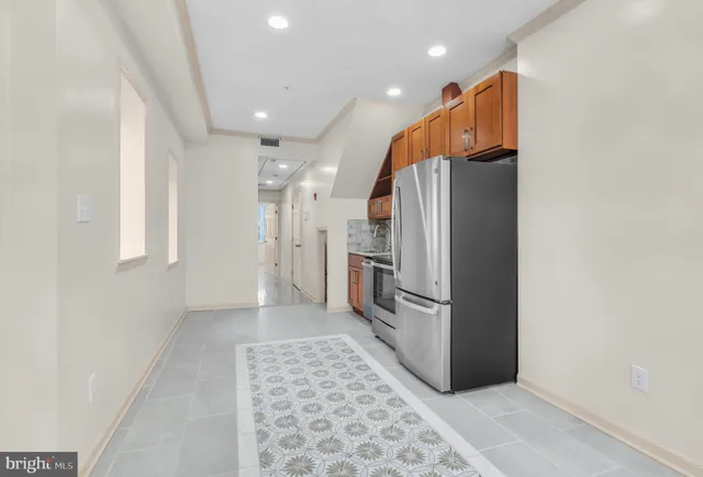 a kitchen with stainless steel appliances granite countertop a refrigerator and a sink