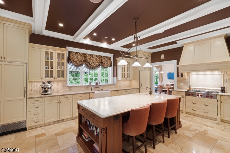 4 Rainetree Ridge Mendham Township, NJ 07945 - Photo 14 of 49 a kitchen with granite countertop a sink a center island and cabinets
