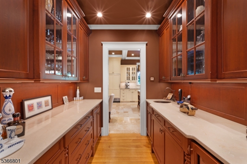 4 Rainetree Ridge Mendham Township, NJ 07945 - Photo 17 of 49 a hallway with a sink and cabinets