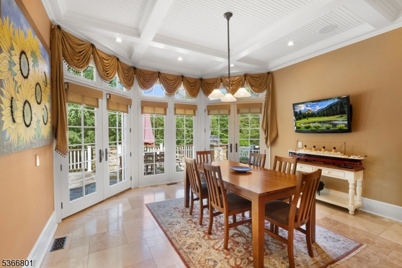 4 Rainetree Ridge Mendham Township, NJ 07945 - Photo 18 of 49 a dining room with furniture a chandelier and wooden floor