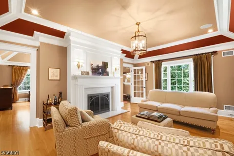 a living room with furniture a window and a fireplace