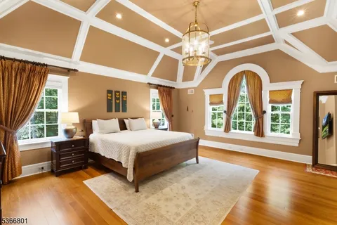 a spacious bedroom with a bed and a large window