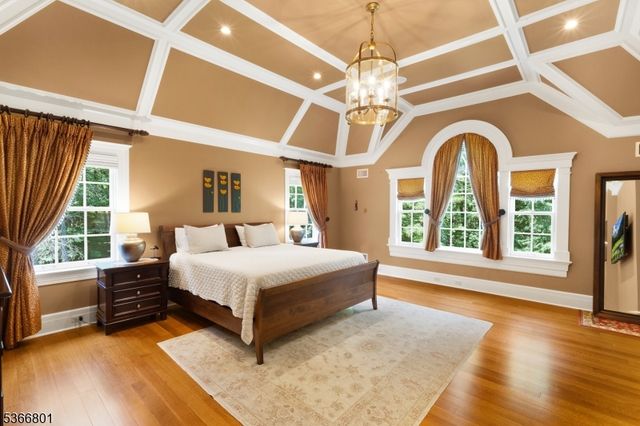 a spacious bedroom with a bed and a large window